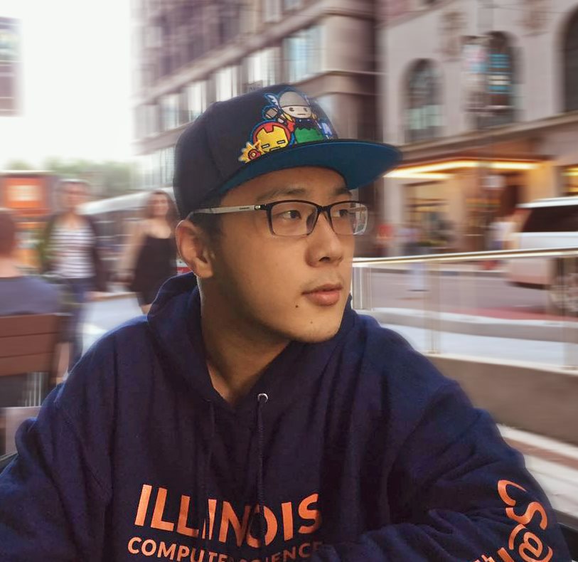 Image of Illinois CS alumnus Bo Chen in 2022 with a scenic city backdrop.