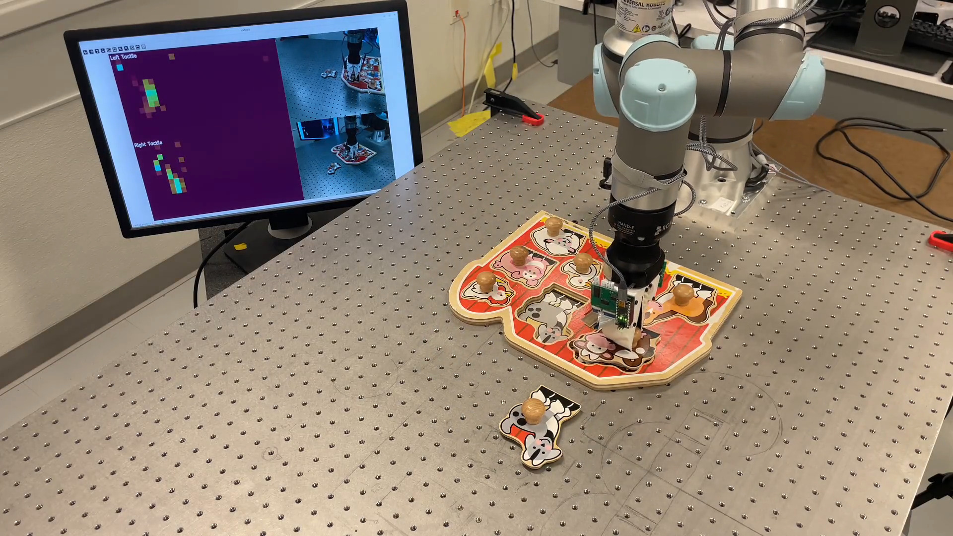 Photo of robot picking up puzzle piece.