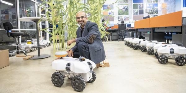 Girish Chowdhary with a TerreSentia robot