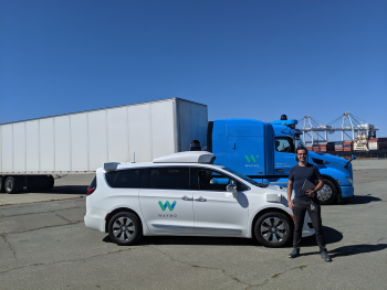 Marinho with a Waymo car and semi