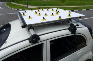 Arrays are mounted to the top of an electric vehicle to measure noise levels. 