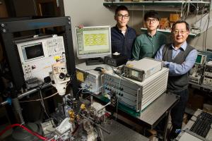University of Illinois engineers developed fiber-optic technology that can transmit data at a blazing-fast 57 gigabits per second, without errors. Pictured are, from left, graduate students Curtis Wang and Michael Liu with CSL Professor Milton Feng.