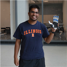 Adeel Akhtar, a student in CSL Professor Tim Bretl's lab, presents a prototype of his 3-D printed prosthetic hand.