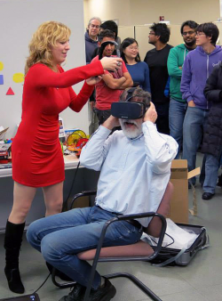 Anna Yershova, a CS alumna and Oculus research scientist helps Prof. Gerald DeJong try out the Oculus Rift HD prototype.