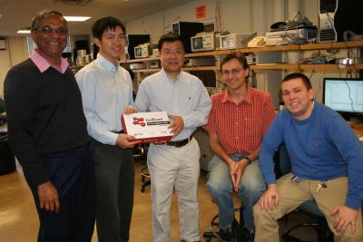 XUP Senior Systems Engineer Parimal Patel, XUP Worldwide Manager Jason Wong and CSL faculty member Deming Chen, along with two graduate students, stand with the Zedboards that Xilinx donated to the University.