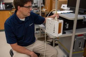 Michael Oelze working on an ultrasound machine.