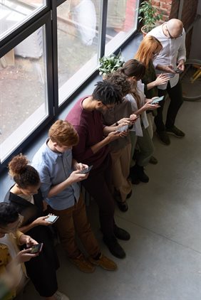 A line of people on their phone